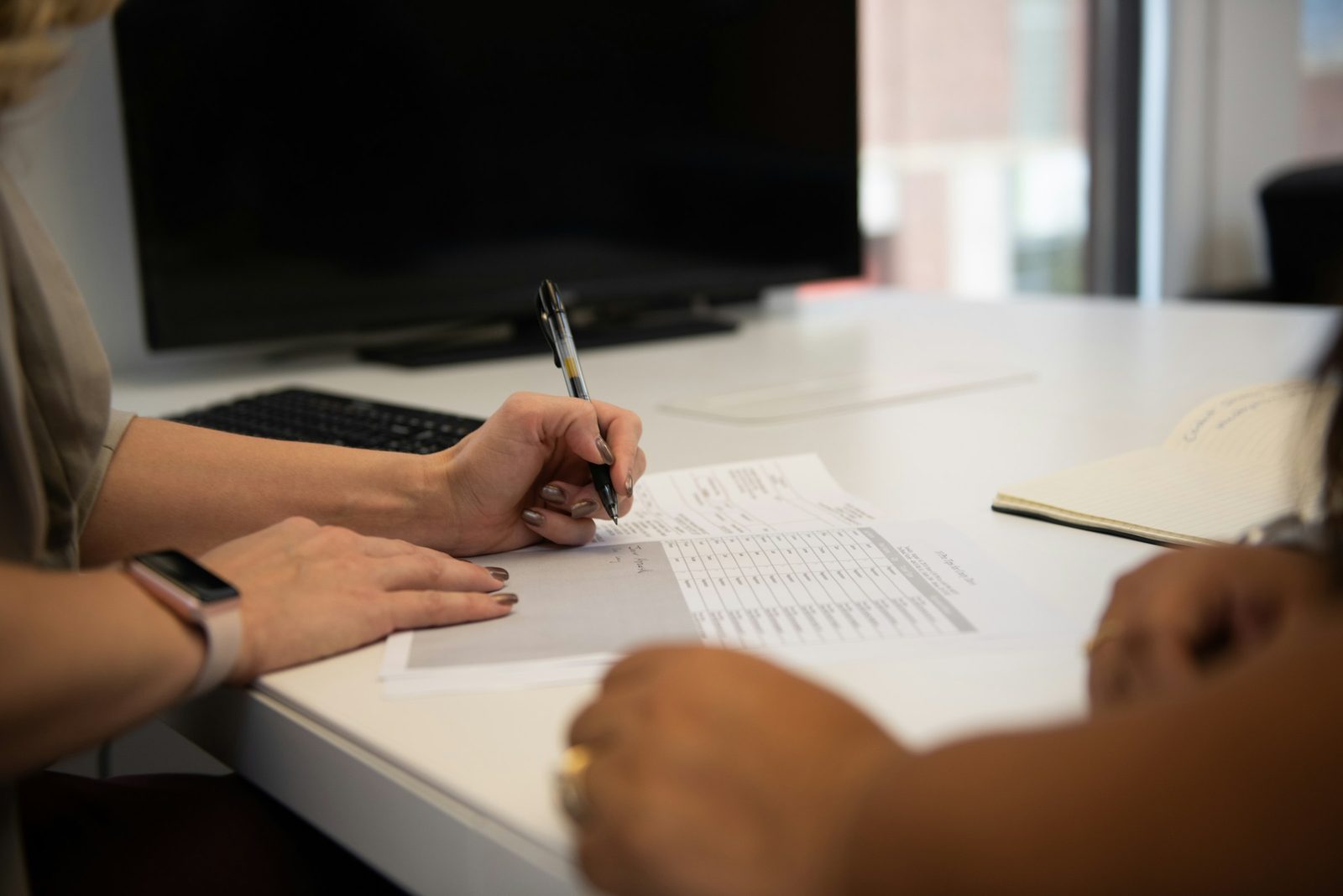 Founder and investor reviewing terms across a table